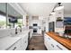 Modern kitchen with a large window, ample counter space, and an island with wood countertop at 7242 E Tyndall St, Mesa, AZ 85207