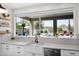 Well-lit kitchen with a large window overlooking the pool and outdoor patio with a view at 7242 E Tyndall St, Mesa, AZ 85207