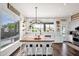 Bright kitchen featuring an island with seating, modern lighting, and ample counter space at 7242 E Tyndall St, Mesa, AZ 85207