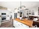 Well-lit kitchen with island and stainless steel appliances open to the living room at 7242 E Tyndall St, Mesa, AZ 85207