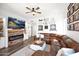 Cozy living room featuring a brick fireplace, modern decor, and comfortable leather seating at 7242 E Tyndall St, Mesa, AZ 85207