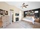 Spacious main bedroom featuring modern decor, large windows, and a cozy fireplace, creating a luxurious retreat at 7242 E Tyndall St, Mesa, AZ 85207
