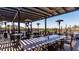 Outdoor patio seating area with heaters, pergola, and views of the golf course at 7242 E Tyndall St, Mesa, AZ 85207