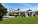 Backyard features a pool, green grass, and manicured landscaping at 7250 E Paradise Dr, Scottsdale, AZ 85260