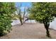 Large backyard with gravel, mature shade trees and swing set for  at 7250 E Paradise Dr, Scottsdale, AZ 85260