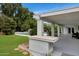 Backyard boasts a covered patio area, lush grass, and inviting pool at 7250 E Paradise Dr, Scottsdale, AZ 85260