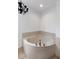Cozy bathroom corner featuring a built-in tub with faucet and ample space for relaxation at 7250 E Paradise Dr, Scottsdale, AZ 85260
