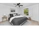 Bright bedroom features a ceiling fan, window shutters, and soothing decor at 7250 E Paradise Dr, Scottsdale, AZ 85260