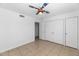 Clean bedroom with tile floors, a baseball ceiling fan, and large closet doors, perfect for storage at 7250 E Paradise Dr, Scottsdale, AZ 85260