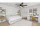 Bright bedroom with a ceiling fan, window with shutters, and ample space for relaxation at 7250 E Paradise Dr, Scottsdale, AZ 85260
