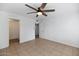 Bare bedroom with ceiling fan offers a view of an open closet, a bathroom, and natural lighting at 7250 E Paradise Dr, Scottsdale, AZ 85260
