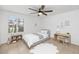 Comfortable bedroom with a ceiling fan and a window with shutters to let the natural light in at 7250 E Paradise Dr, Scottsdale, AZ 85260