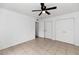 Bedroom featuring a ceiling fan and double closet with white doors at 7250 E Paradise Dr, Scottsdale, AZ 85260