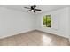 Bedroom featuring a ceiling fan and window with shutters at 7250 E Paradise Dr, Scottsdale, AZ 85260