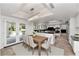 Dining area with stainless steel appliances, stylish chandelier, and backyard view at 7250 E Paradise Dr, Scottsdale, AZ 85260