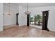 Open dining room with tile floors, large window, and elegant chandelier lighting at 7250 E Paradise Dr, Scottsdale, AZ 85260