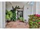 Charming front entrance featuring decorative plants, an arched front door, and stone walkway at 7250 E Paradise Dr, Scottsdale, AZ 85260