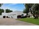View of the home's garage, landscaping, and white exterior at 7250 E Paradise Dr, Scottsdale, AZ 85260