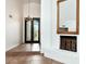 Foyer featuring tile floor, a decorative fireplace, and a large glass front door at 7250 E Paradise Dr, Scottsdale, AZ 85260