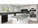 Modern kitchen with granite countertops, stainless steel appliances, and white cabinets at 7250 E Paradise Dr, Scottsdale, AZ 85260