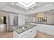 Spacious kitchen with stainless steel appliances, granite countertops, and a skylight at 7250 E Paradise Dr, Scottsdale, AZ 85260