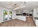 Open kitchen layout with island, stainless appliances, and access to outdoor living area at 7250 E Paradise Dr, Scottsdale, AZ 85260