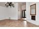 Living room with tile floor, decorative fireplace, and chandelier lighting at 7250 E Paradise Dr, Scottsdale, AZ 85260