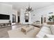 Spacious living room with fireplace, light color palette and ample seating at 7250 E Paradise Dr, Scottsdale, AZ 85260