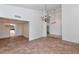 Spacious living room with tile floors and chandelier lighting; kitchen entrance in background at 7250 E Paradise Dr, Scottsdale, AZ 85260
