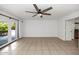Bright living room with tile floors, a ceiling fan, and sliding glass doors leading to the outdoors at 7250 E Paradise Dr, Scottsdale, AZ 85260