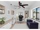Cozy home office with custom desk, a comfortable blue couch, and a relaxing space to focus and work at 7250 E Paradise Dr, Scottsdale, AZ 85260