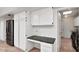 Pantry area with stainless steel refrigerator, built-in desk and storage cabinets at 7250 E Paradise Dr, Scottsdale, AZ 85260
