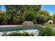 Beautiful backyard pool with a stone waterfall feature and lush landscaping at 7250 E Paradise Dr, Scottsdale, AZ 85260