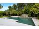 Beautiful backyard pool with a stone waterfall feature and lush landscaping at 7250 E Paradise Dr, Scottsdale, AZ 85260