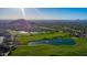 Scenic aerial view of lush golf course with serene lakes against mountain backdrop, showcasing outdoor beauty at 7445 E Eagle Crest Dr # 1122, Mesa, AZ 85207
