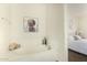 Bathroom featuring a soaking tub with a view, ambient lighting, and modern fixtures at 7445 E Eagle Crest Dr # 1122, Mesa, AZ 85207