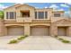 Modern stucco homes with three car garages, upper balconies, and stone accents on a smooth concrete driveway at 7445 E Eagle Crest Dr # 1122, Mesa, AZ 85207