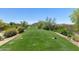 Scenic golf course view with lush green fairway, desert landscaping, and distant mountain views at 7445 E Eagle Crest Dr # 1122, Mesa, AZ 85207