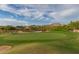 Expansive golf course landscape with a green, sand traps, desert vegetation, and mountain backdrop under a partly cloudy sky at 7445 E Eagle Crest Dr # 1122, Mesa, AZ 85207