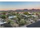 Breathtaking aerial view showcases a neighborhood with stunning mountain vistas and vibrant sunset hues at 8644 E Sweetwater Ave, Scottsdale, AZ 85260