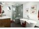 Bright bathroom featuring a soaking tub, glass-enclosed shower, and modern fixtures at 8644 E Sweetwater Ave, Scottsdale, AZ 85260