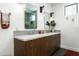 A bathroom with a double sink vanity, modern fixtures, and decorative mirrors at 8644 E Sweetwater Ave, Scottsdale, AZ 85260