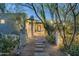 Paver walkway leads to the home's front door, nestled behind desert landscaping and modern architectural elements at 8644 E Sweetwater Ave, Scottsdale, AZ 85260