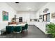 Modern kitchen with white cabinetry, stone countertops, stainless appliances, and adjacent dining area at 8644 E Sweetwater Ave, Scottsdale, AZ 85260