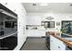 Sleek, all-white kitchen featuring modern appliances, ample cabinetry, and eat-in dining area at 8644 E Sweetwater Ave, Scottsdale, AZ 85260