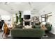 Bright living room with fireplace, indoor plants, and modern decor creates a welcoming space at 8644 E Sweetwater Ave, Scottsdale, AZ 85260