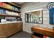 A well-appointed office space with built-in shelving, a large window, and modern decor at 8644 E Sweetwater Ave, Scottsdale, AZ 85260