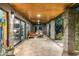 Covered patio area featuring stone flooring, wood ceiling, block construction, and stylish outdoor furniture at 8644 E Sweetwater Ave, Scottsdale, AZ 85260