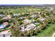 Scottsdale home's aerial view showcases pristine landscaping, a pool, and golf course proximity at 87 Biltmore Est, Phoenix, AZ 85016