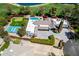 Beautiful aerial view showcasing a private tennis court and putting green next to a luxury home in Scottsdale, AZ at 87 Biltmore Est, Phoenix, AZ 85016
